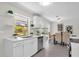Kitchen with stainless steel appliances, modern countertops, and open view to the dining area at 822 Oakview Dr, New Smyrna Beach, FL 32169