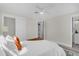 Bright main bedroom with white linens, ceiling fan, and ample closet space at 822 Oakview Dr, New Smyrna Beach, FL 32169