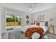 Cozy main bedroom with sliding glass doors to the backyard, offering natural light and space at 822 Oakview Dr, New Smyrna Beach, FL 32169
