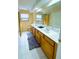 Bathroom featuring a double vanity, tile flooring, and a shower with glass doors, all bathed in natural light at 871 Blairmont Ln, Lake Mary, FL 32746