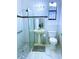 Updated bathroom with white tile, glass shower, and modern fixtures at 871 Blairmont Ln, Lake Mary, FL 32746