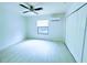 Bright bedroom with white walls and light wood flooring, a ceiling fan, AC unit, window and a closet with sliding doors at 871 Blairmont Ln, Lake Mary, FL 32746