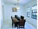 Formal dining room features an elegant chandelier, tile flooring, and large arched windows at 871 Blairmont Ln, Lake Mary, FL 32746