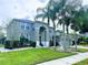 Charming two-story home features a lush lawn, palm trees and a side entry two car garage at 871 Blairmont Ln, Lake Mary, FL 32746