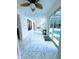 Bright hallway featuring marble tile flooring, a fan, and sliding glass doors leading to a screened-in pool area at 871 Blairmont Ln, Lake Mary, FL 32746