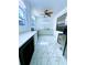 Clean and modern kitchen featuring white cabinets, marble tile flooring, and stainless steel appliances at 871 Blairmont Ln, Lake Mary, FL 32746