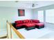 Bright living room with a red sofa, ceiling fan, and white floors, providing a comfortable and stylish space at 871 Blairmont Ln, Lake Mary, FL 32746