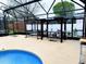 Outdoor pool area with a covered outdoor kitchen, BBQ, swing and seating, perfect for entertaining and relaxation at 871 Blairmont Ln, Lake Mary, FL 32746