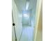 Walk-in closet with white walls and floors, a window on one end, and door on the other, offering ample storage space at 871 Blairmont Ln, Lake Mary, FL 32746