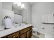 Bright bathroom featuring a light countertop vanity, a large mirror, and neutral wall paint at 970 Glazebrook Loop, Orange City, FL 32763