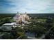 A high-angle shot features a hotel, surrounded by lush greenery and golf courses at 7404 Oconee St, Reunion, FL 34747