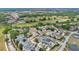 An aerial view of a residential area featuring houses, green trees, golf courses, and lush greenery at 7404 Oconee St, Reunion, FL 34747