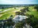 Aerial view showcasing the golf course and pool, surrounded by lush greenery at 7404 Oconee St, Reunion, FL 34747