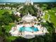 Aerial view of resort community with a swimming pool, golf course, and lush landscaping at 7404 Oconee St, Reunion, FL 34747