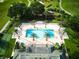 Aerial view of a resort swimming pool surrounded by palm trees and grassy areas at 7404 Oconee St, Reunion, FL 34747