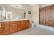 Bathroom with double sinks, wood cabinets, and a shower/tub combo with a decorative curtain at 7404 Oconee St, Reunion, FL 34747