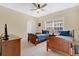 Traditional bedroom featuring two twin beds, a ceiling fan, and a wooden dresser at 7404 Oconee St, Reunion, FL 34747