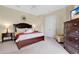 Comfortable bedroom with a plush bed, bedside tables, and soft carpeting at 7404 Oconee St, Reunion, FL 34747