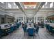 Expansive dining room with high ceilings and blue chairs, perfect for hosting large gatherings at 7404 Oconee St, Reunion, FL 34747