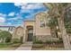Beautiful two-story home with stone accents, lush landscaping, and a welcoming front entrance at 7404 Oconee St, Reunion, FL 34747