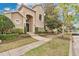 Charming home exterior with well-maintained landscaping, a paved walkway, and a serene setting at 7404 Oconee St, Reunion, FL 34747