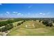 Vast golf course highlighting the expansive green landscape, dotted with trees and pristine fairways at 7404 Oconee St, Reunion, FL 34747