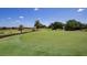 Scenic golf course showcasing lush green grass, palm trees, and well-maintained putting greens at 7404 Oconee St, Reunion, FL 34747