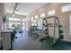 Well-equipped gym featuring exercise equipment, including treadmills, weight machines, and free weights with natural lighting at 7404 Oconee St, Reunion, FL 34747