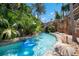 Relaxing lazy river with lush tropical landscaping and a small waterfall feature at 7404 Oconee St, Reunion, FL 34747