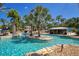Scenic lazy river with islands, bridges, and shaded cabanas for ultimate relaxation by the pool at 7404 Oconee St, Reunion, FL 34747