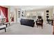 Spacious living room with built-in shelves, large windows, and comfortable seating at 7404 Oconee St, Reunion, FL 34747