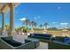 Elegant outdoor seating area with comfortable seating and palm trees under a blue sky at 7404 Oconee St, Reunion, FL 34747