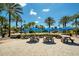 Beach area featuring picnic tables, palm trees, benches, and easy access to the pool area at 7404 Oconee St, Reunion, FL 34747