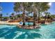 Picturesque lazy river with tropical landscaping, rock features, and clear blue water at 7404 Oconee St, Reunion, FL 34747