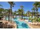 Resort-style pool features a lazy river, palm trees, and comfortable lounge chairs at 7404 Oconee St, Reunion, FL 34747
