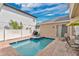 Backyard view with pool, spa, table set, and chairs on a brick patio, surrounded by white fences at 7404 Oconee St, Reunion, FL 34747