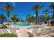 Resort-style pool with lounge chairs and palm trees under a clear blue sky at 7404 Oconee St, Reunion, FL 34747