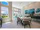Well-lit recreation room with large windows, tables, chairs, and a stylish serving counter with decor at 7404 Oconee St, Reunion, FL 34747