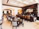 Upscale bar and seating area with dark wood accents and comfortable chairs at 7404 Oconee St, Reunion, FL 34747