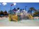 Interactive splash pad with colorful structures and a dumping bucket for Gathering fun at 7404 Oconee St, Reunion, FL 34747