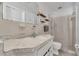 Bright bathroom featuring a white vanity and shower with white tile surround at 2829 Aloma Ave, Winter Park, FL 32792