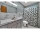 Bathroom featuring a vanity with a large mirror and a bathtub with a shower curtain at 2829 Aloma Ave, Winter Park, FL 32792