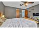 Comfortable bedroom featuring a ceiling fan, wooden accents, and neutral wall color at 2829 Aloma Ave, Winter Park, FL 32792