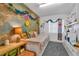 Bright bedroom decorated with a world map wall and a white shelving unit at 2829 Aloma Ave, Winter Park, FL 32792