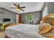 A comfortable bedroom with a bright window, soft bedding, and a ceiling fan provides a relaxing atmosphere at 2829 Aloma Ave, Winter Park, FL 32792