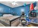 Blue bedroom with a ceiling fan, desk, and gaming chair at 2829 Aloma Ave, Winter Park, FL 32792