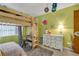 Fun bedroom with a lofted bed, keyboard, and a white dresser at 2829 Aloma Ave, Winter Park, FL 32792