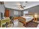 This cozy bedroom has a ceiling fan, a wooden bed frame, and decor, creating a snug retreat at 2829 Aloma Ave, Winter Park, FL 32792