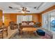 Inviting Living room featuring comfortable leather seating, ceiling fan, and sliding door access to outdoor area at 2829 Aloma Ave, Winter Park, FL 32792