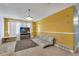 Bright yellow living room, featuring a large window, tv, rug, and comfortable seating at 2829 Aloma Ave, Winter Park, FL 32792